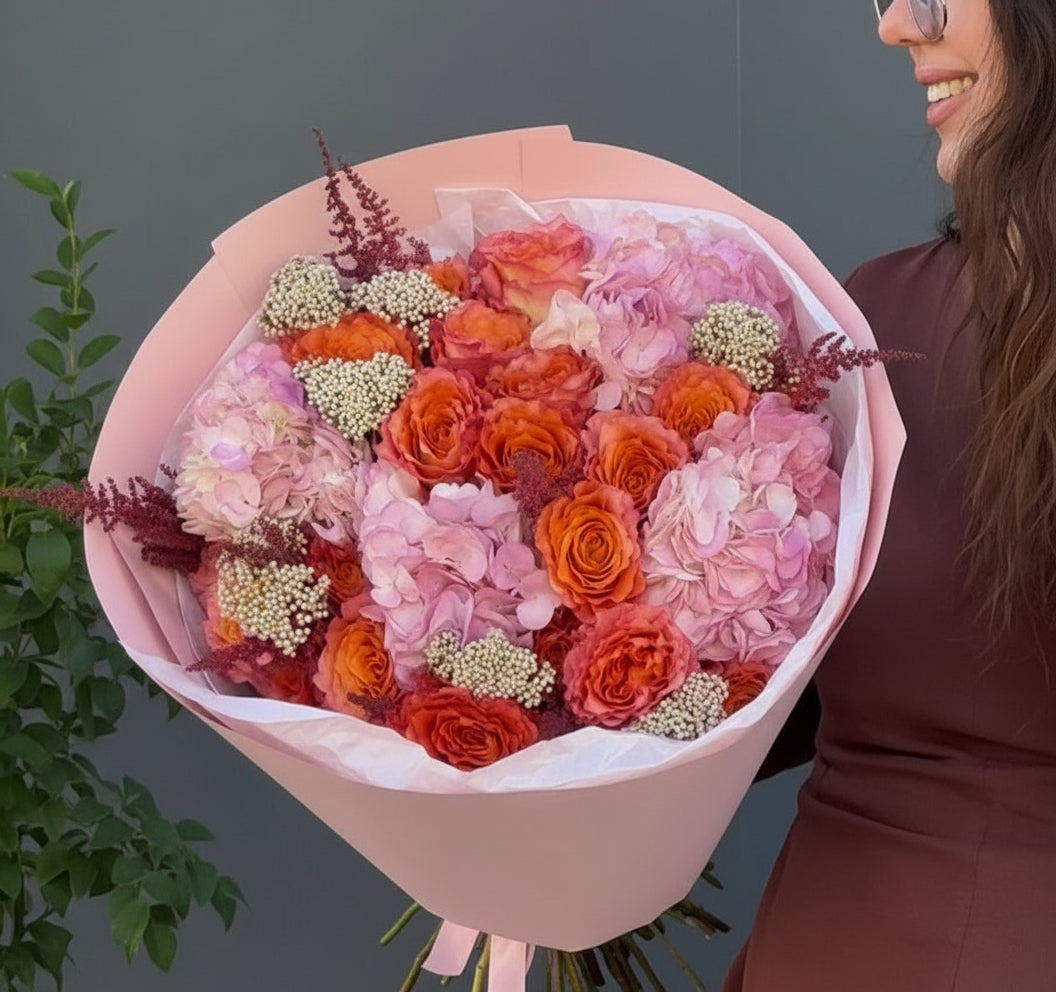 Roses and hydrangeas in hand =tied bouquet